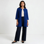 Model wearing a Lynn's Closet Boutique cobalt blue textured knit cardigan with patch pockets and a button-front closure.