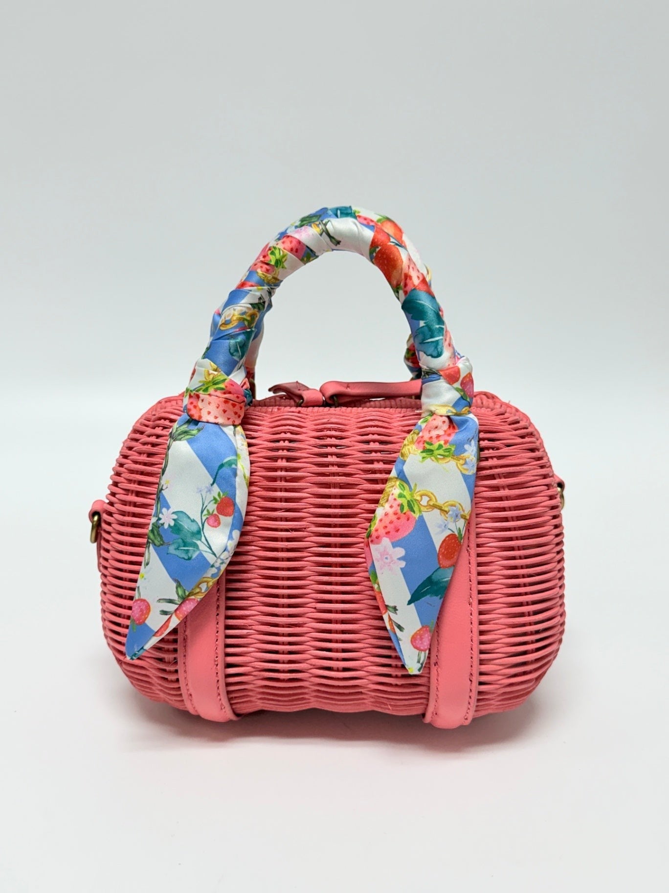 Lynn's Closet Boutique coral woven basket Boston bag with a strawberry print scarf wrapped handle.