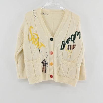 Lynn's Closet Boutique cream cable knit cardigan featuring colorful patchwork, embroidered lettering, and button front.