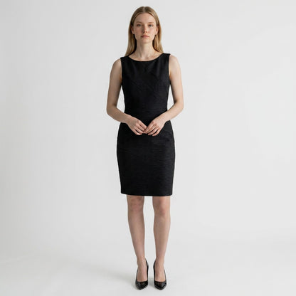 Lynn's Closet Boutique David Meister black sleeveless mini dress with textured diagonal seams on a model
