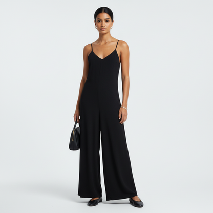 Model wearing an Eileen Fisher black V-neck jumpsuit with spaghetti straps from Lynn's Closet Boutique