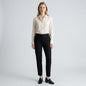 Lynn's Closet Boutique Eileen Fisher black tapered ankle pants worn by a model with a cream blouse and loafers