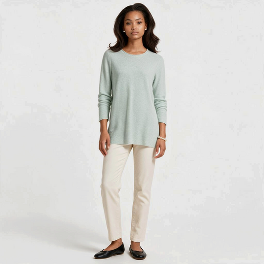 Model wearing a Lynn's Closet Boutique Eileen Fisher mint green textured crew neck sweater with cream trousers
