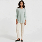 Model wearing a Lynn's Closet Boutique Eileen Fisher mint green textured crew neck sweater with cream trousers