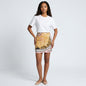 Model wearing a Lynn's Closet Boutique vintage Emanuel Ungaro baroque print mini skirt with a white t-shirt.