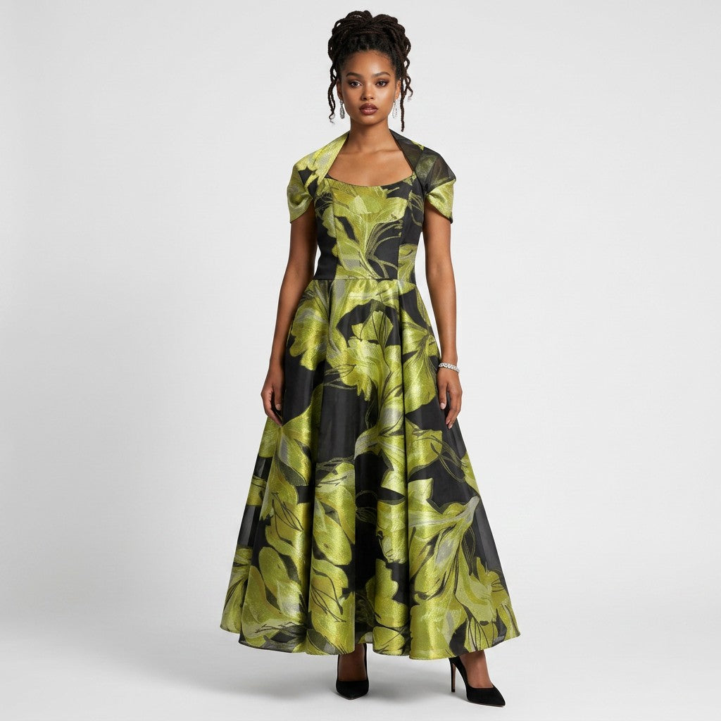 Model wearing a Lynn's Closet Boutique strapless black and lime green floral A-line gown with a matching bolero jacket.