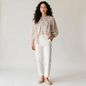 Model wearing Lynn's Closet Boutique floral smocked puff sleeve blouse with white trousers and espadrilles