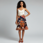 Model wearing a Lynn's Closet Boutique Manzoni Couture floral ruffle skirt with orange and cream painterly motifs