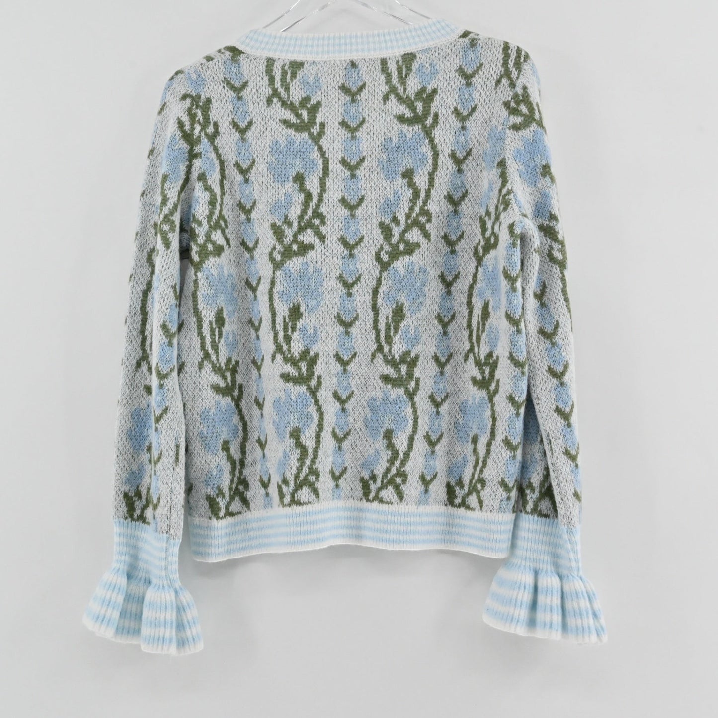 Lynn's Closet Boutique So Me floral wool cardigan featuring blue flowers, green stems, and ruffled cuffs, back view.