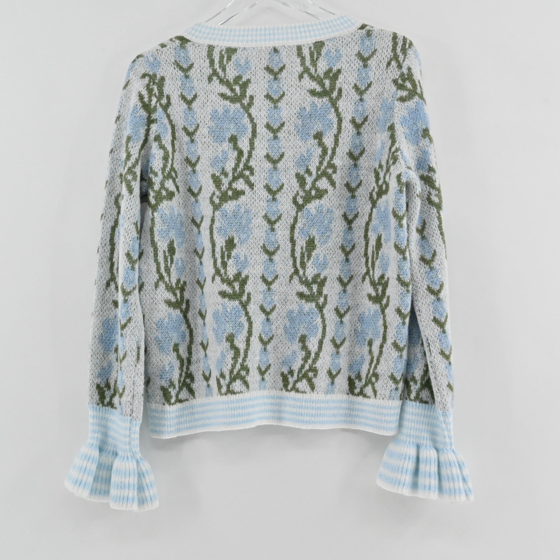 Lynn's Closet Boutique So Me floral wool cardigan featuring blue flowers, green stems, and ruffled cuffs, back view.