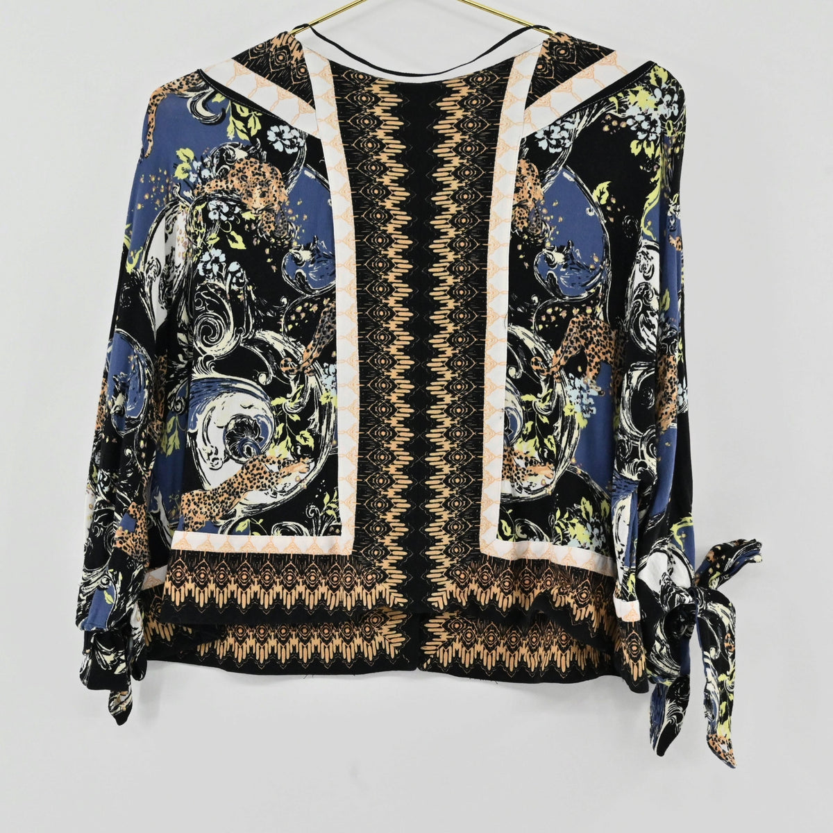 Lynn's Closet Boutique Free People bohemian top with multi-colored floral print, V-neck, and tie-sleeve details.