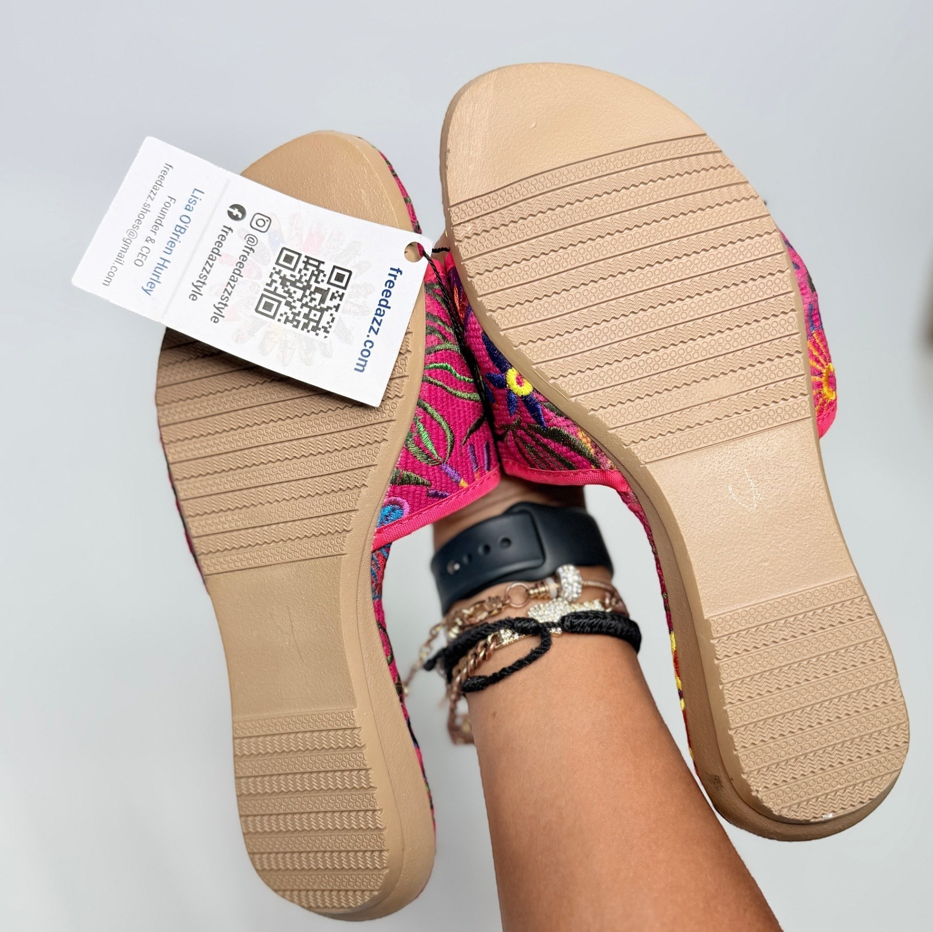 Lynn's Closet Boutique FreeDazz fuchsia slides with floral embroidery and textured rubber soles held by a person