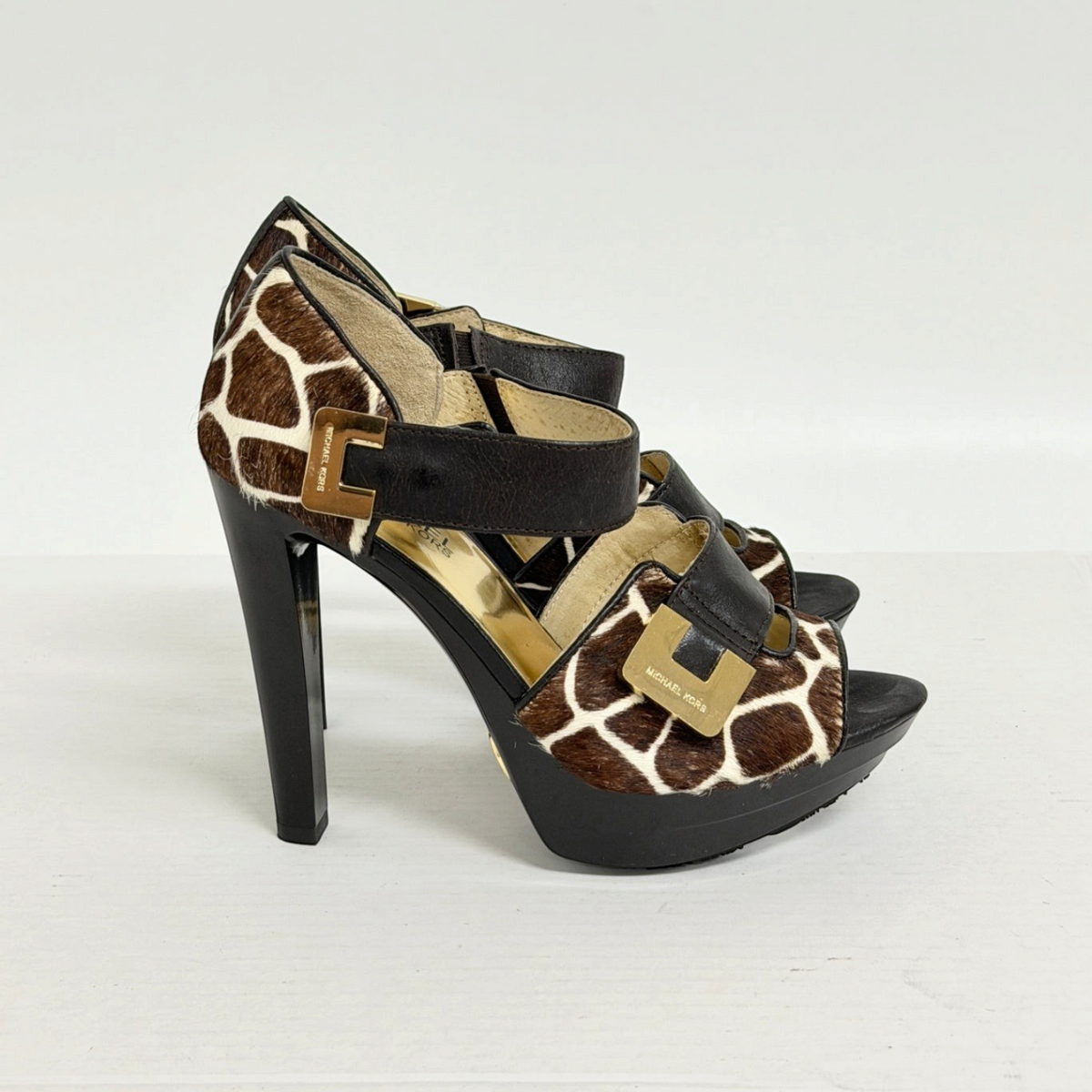 Lynn's Closet Boutique Michael Kors giraffe print calf hair platform heels with gold buckles and ankle straps.