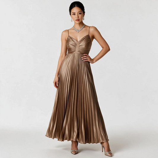 Model wearing a Lynn's Closet Boutique gold pleated maxi dress with spaghetti straps and a ruched bodice.