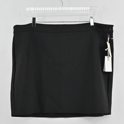 Lynn's Closet Boutique Good American black mini skirt with tags hanging on a clear hanger against a white background.
