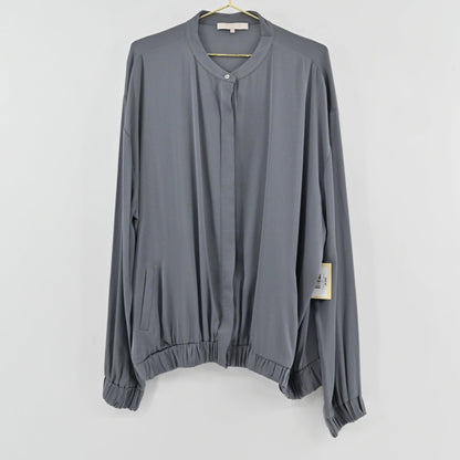 Lynn's Closet Boutique Nouvelle slate gray silk-feel blouse with a collarless button-front and elasticized hem.