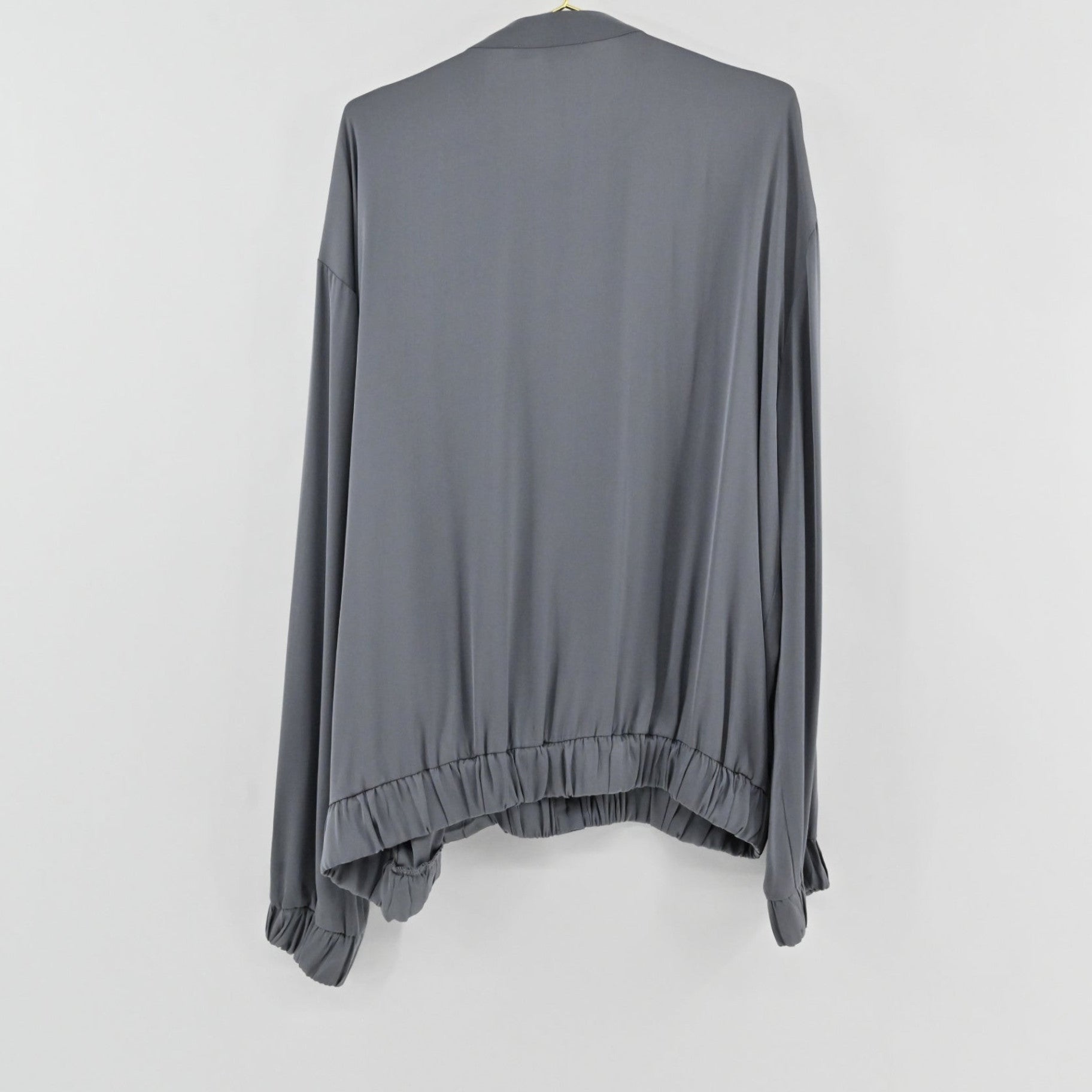 Lynn's Closet Boutique slate gray silk-feel top with a relaxed fit, elasticized hem, and cuffed sleeves, back view.