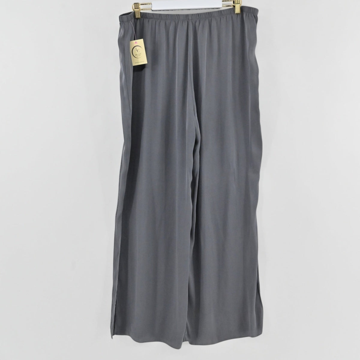Lynn's Closet Boutique gray silk-blend wide-leg pants with an elastic waistband hanging on a white background.
