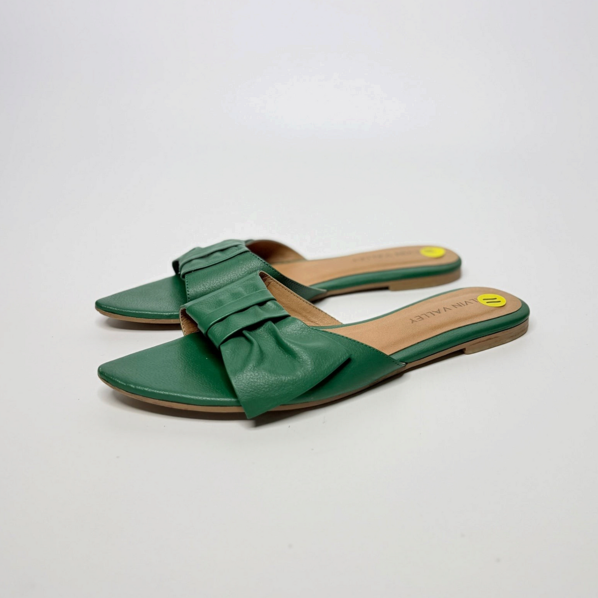 Lynn's Closet Boutique Alvin Valley green pointed-toe flat sandals featuring a pleated bow accent on the strap.
