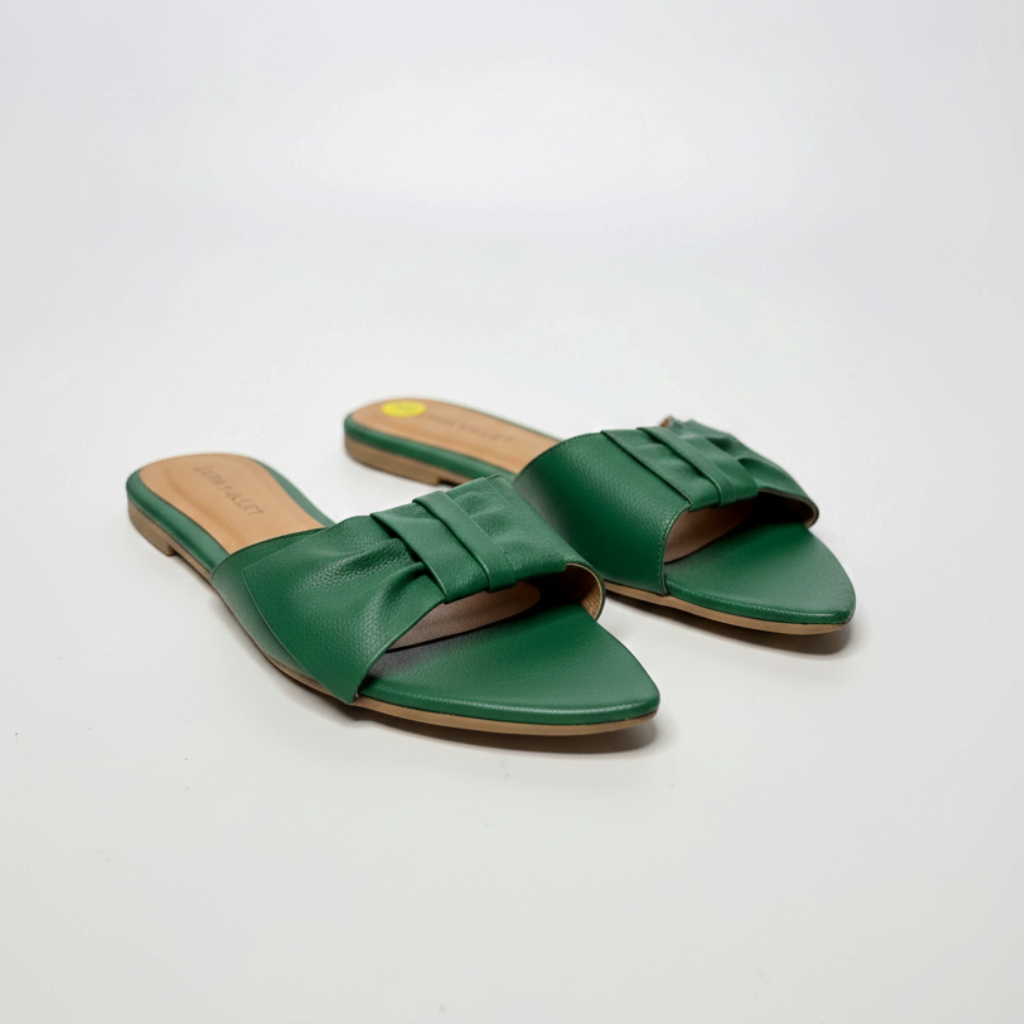 Lynn's Closet Boutique Alvin Valley green pointed-toe flat sandals with a pleated bow accent on a white background.