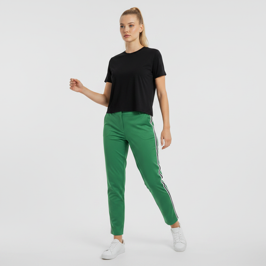 Lynn's Closet Boutique Tory Burch Sport green trousers with side stripes worn by a model with a black t-shirt