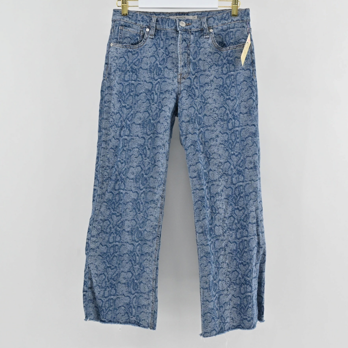 Lynn's Closet Boutique Hudson blue straight-leg jeans with an all-over snakeskin print and a raw frayed hem.