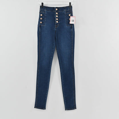 Lynn's Closet Boutique J Brand Natasha high-rise skinny jeans in dark wash denim with exposed button-fly closure.