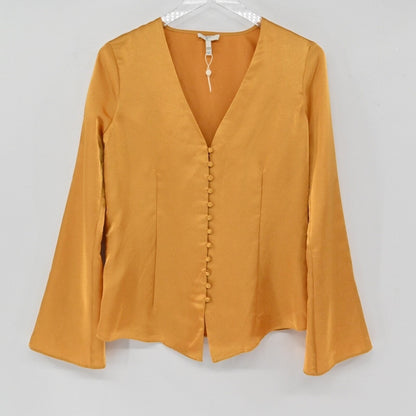 Lynn's Closet Boutique Joie Madora golden-mustard silky bell sleeve top with V-neck and fabric-covered buttons.