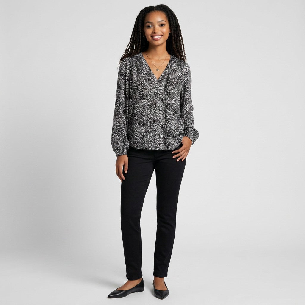 Lynn's Closet Boutique Joie silk animal print blouse with long sleeves and V-neck worn by a smiling model.