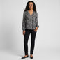 Lynn's Closet Boutique Joie silk animal print blouse with long sleeves and V-neck worn by a smiling model.