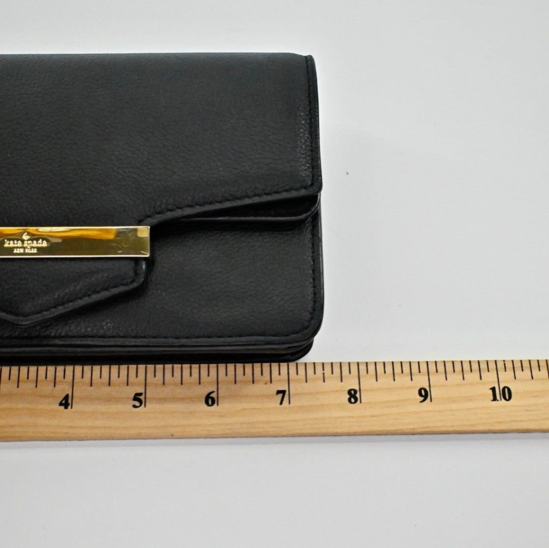 Lynn's Closet Boutique Kate Spade black pebbled leather Kaela Carmel Court crossbody bag with gold-tone metal bar.