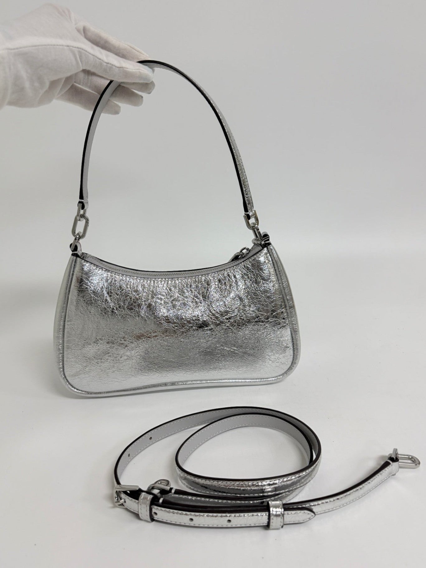 Lynn's Closet Boutique Kate Spade silver crinkle metallic shoulder bag with a removable crossbody strap.