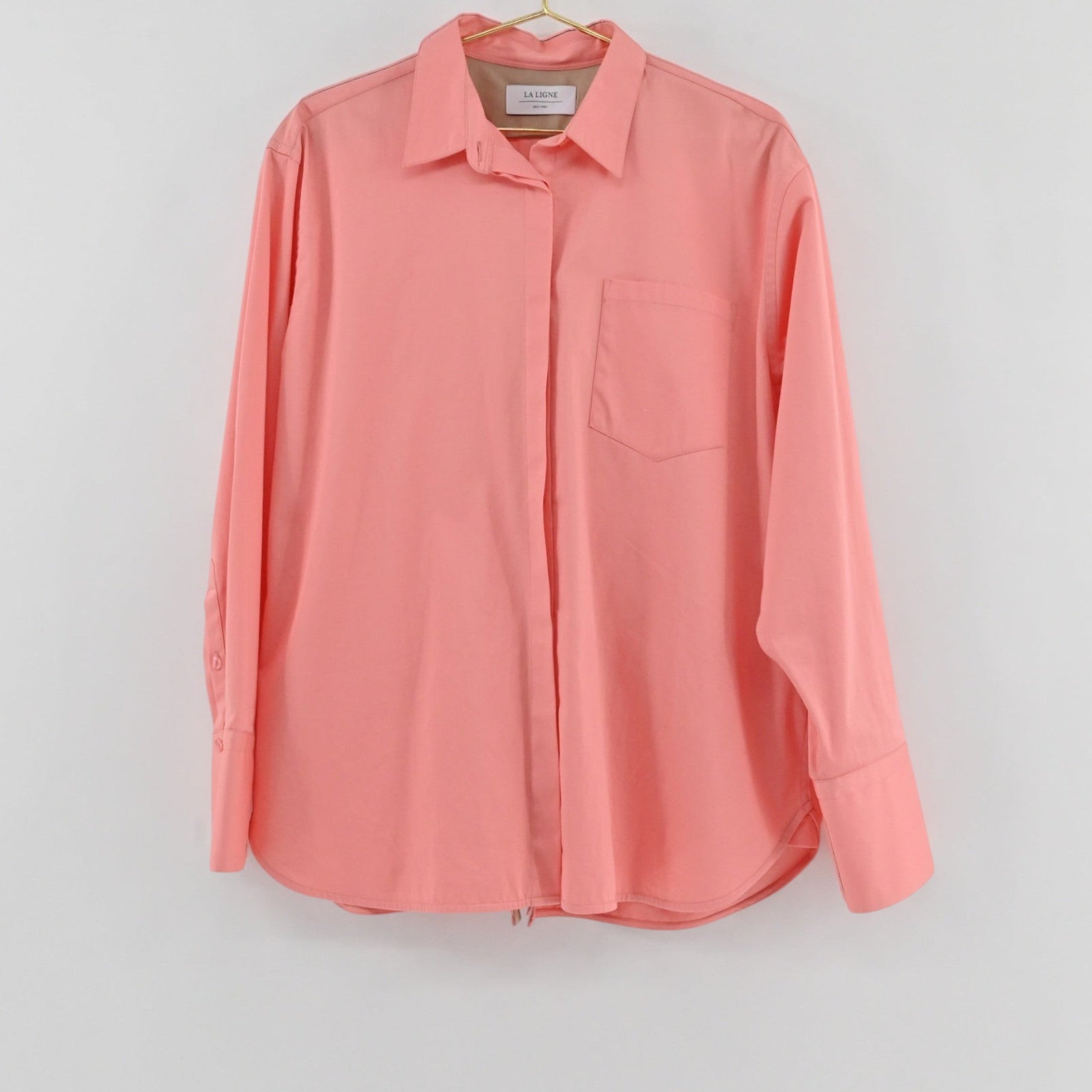 Lynn's Closet Boutique La Ligne coral button-down shirt with a classic collar, chest pocket, and wide cuffs.