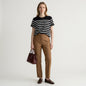 Model wearing a Lynn's Closet Boutique La Ligne black and white striped crew neck t-shirt with a chest pocket