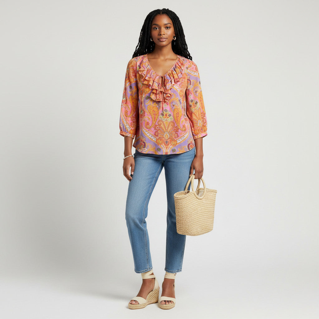 Model wearing a Lynn's Closet Boutique Lauren Ralph Lauren pink and orange paisley top with a ruffled neckline.