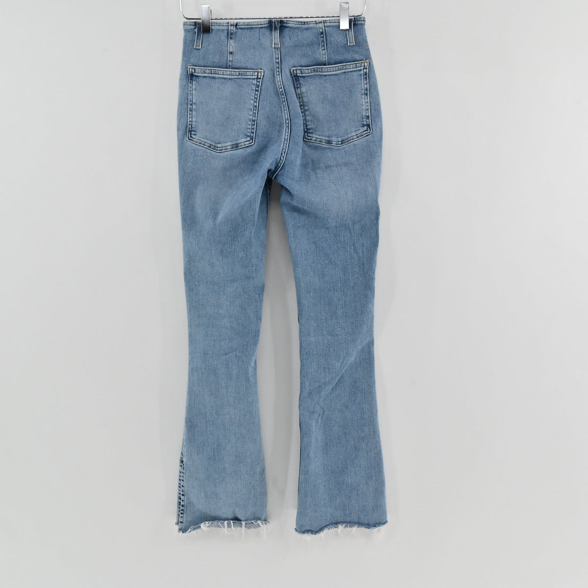 Lynn's Closet Boutique light wash high-rise flare jeans with back pockets and frayed split hem detail