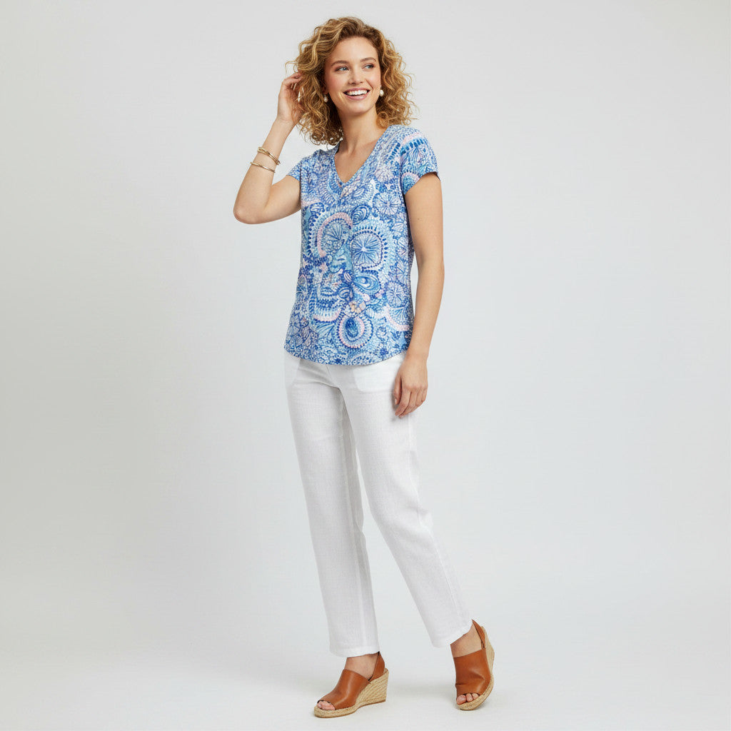 Model wearing a blue Lilly Pulitzer Etta Tee with a paisley print and white trousers from Lynn's Closet Boutique