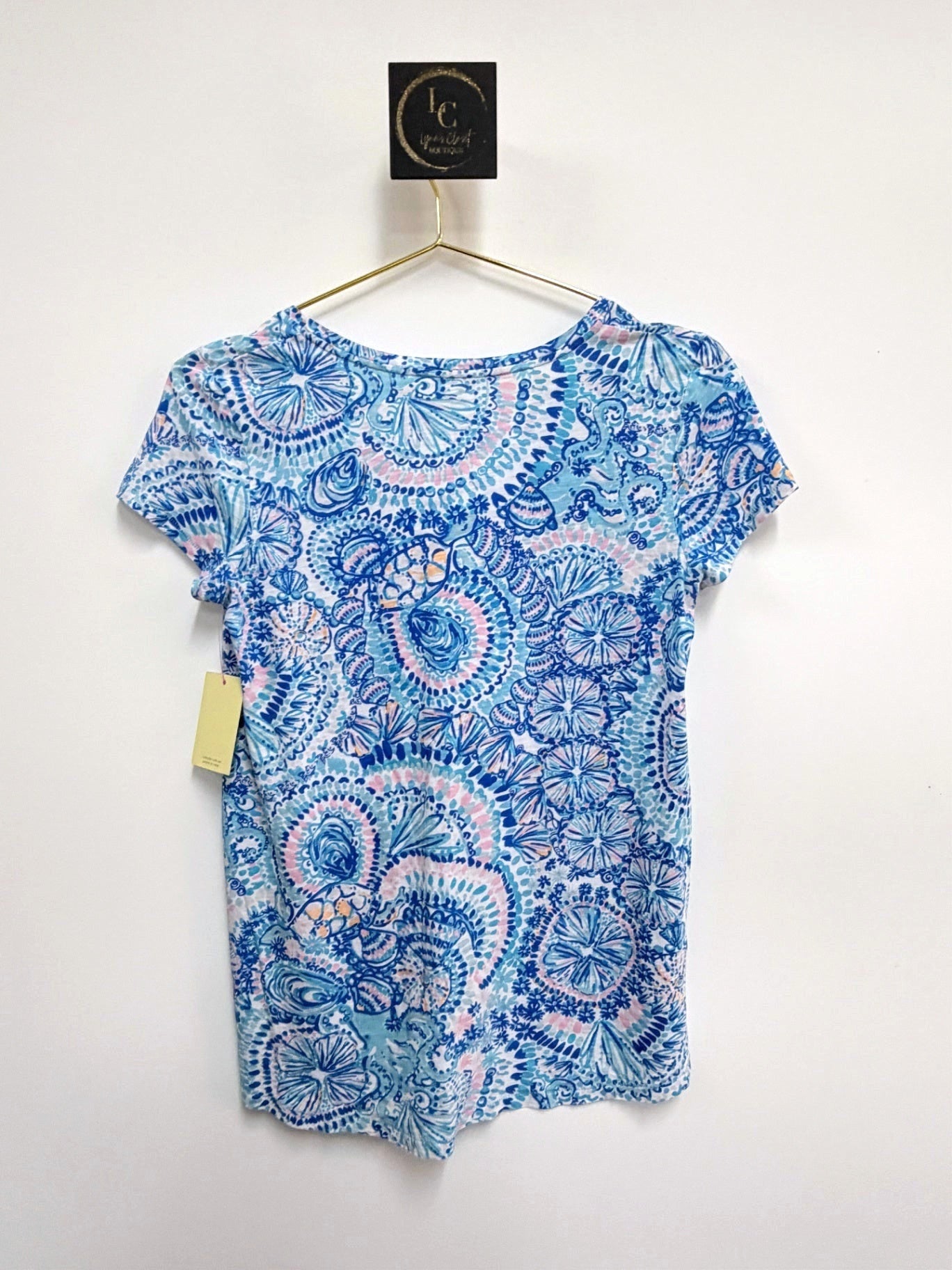 Lynn's Closet Boutique Lilly Pulitzer Etta short-sleeve tee featuring a blue and pink kaleidoscope print on a hanger.