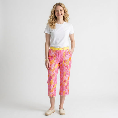 Model wearing Lynn's Closet Boutique Lilly Pulitzer pink and orange monkey print cropped pants with yellow waistband.