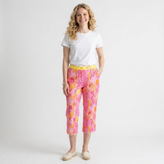 Model wearing Lynn's Closet Boutique Lilly Pulitzer pink and orange monkey print cropped pants with yellow waistband.