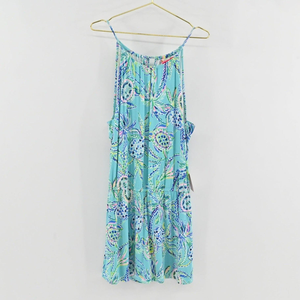 Lynn's Closet Boutique Lilly Pulitzer Gianni skort romper in blue turtle print with a halter neckline on a hanger