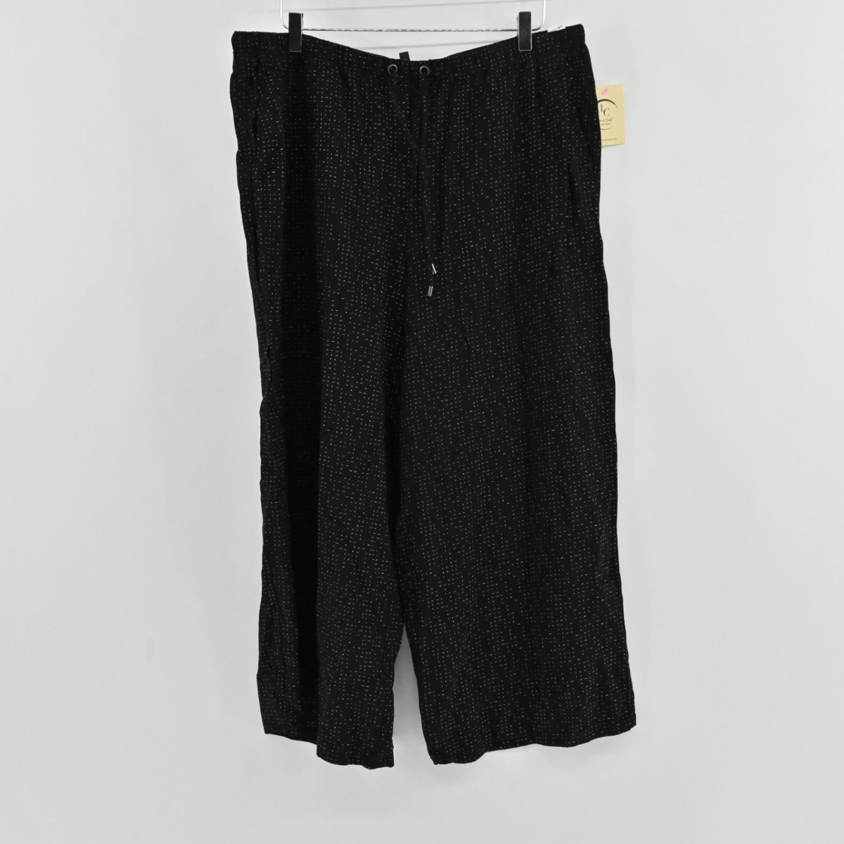 Lynn's Closet Boutique Eileen Fisher metallic black wide-leg pants with a drawstring waist and white dot pattern.
