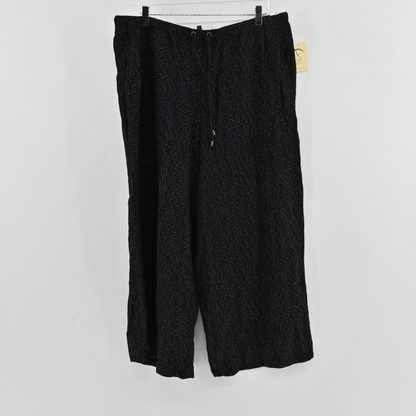 Lynn's Closet Boutique Eileen Fisher metallic black wide-leg pants with a drawstring waist and white dot pattern.