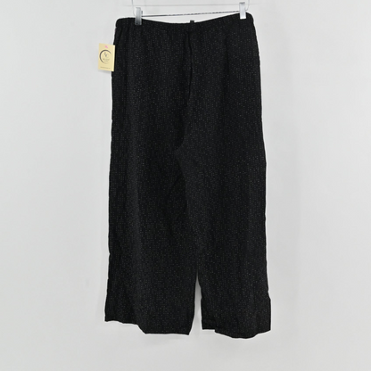 Lynn's Closet Boutique Eileen Fisher metallic black wide-leg pants with subtle white dot pattern and elastic waist.