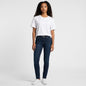 Model wearing Lynn's Closet Boutique Michael Kors dark wash skinny jeans with a white t-shirt and sneakers