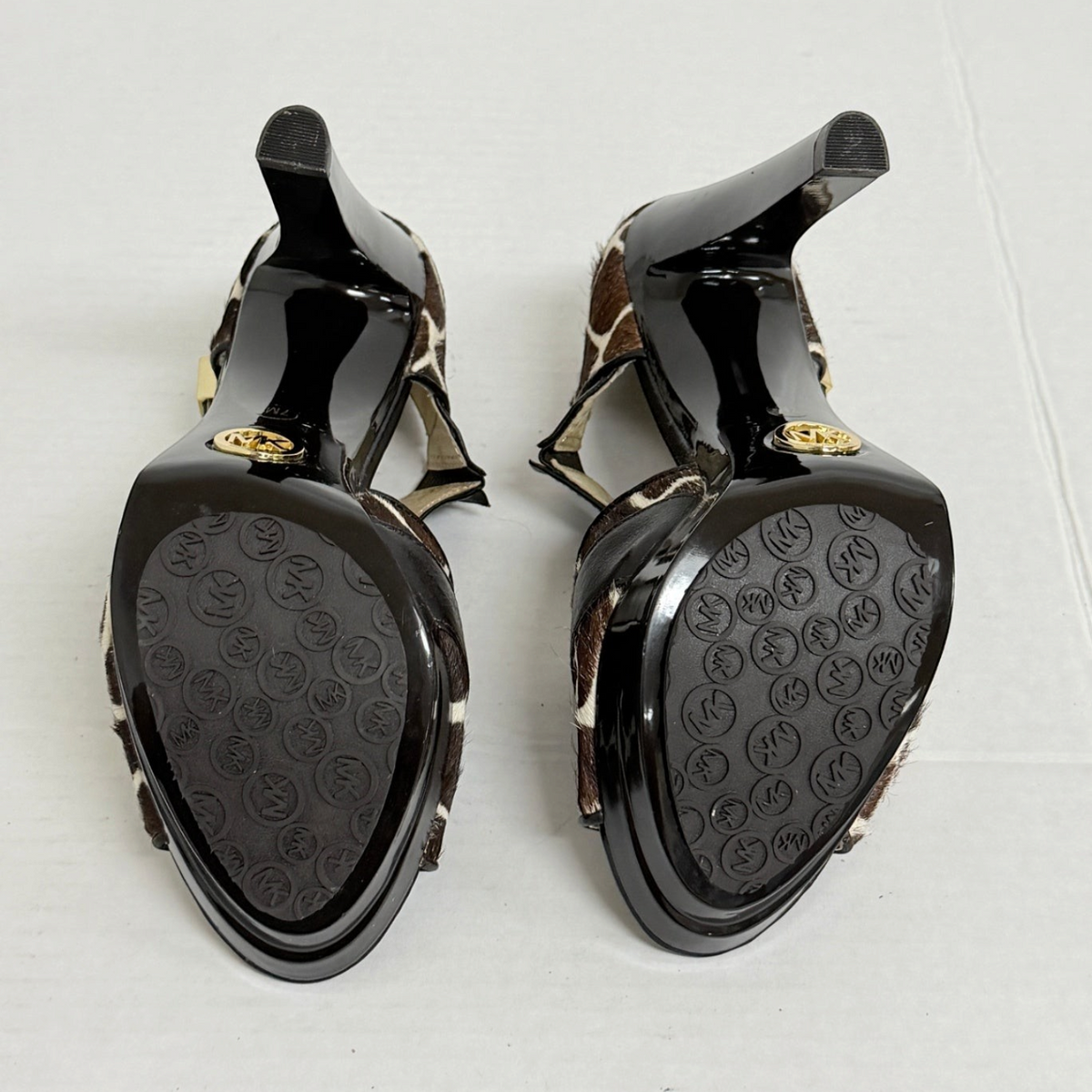 Lynn's Closet Boutique Michael Kors giraffe print calf hair platform heels showing the black soles with MK logo