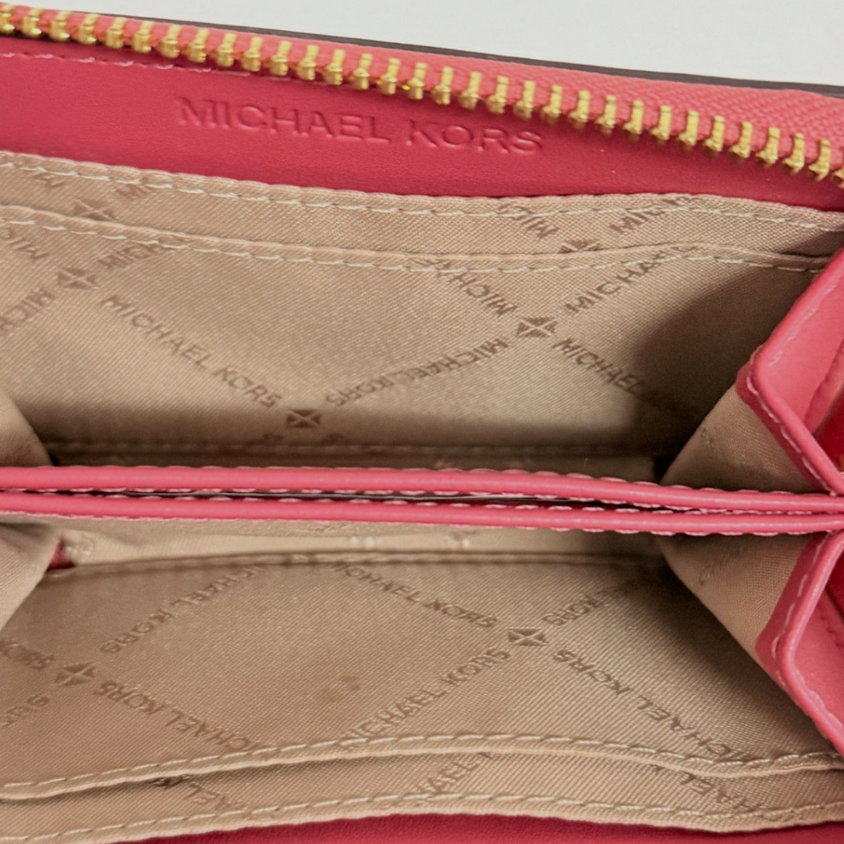 Interior of Lynn's Closet Boutique Michael Kors red leather card case with signature logo fabric lining and gold zipper