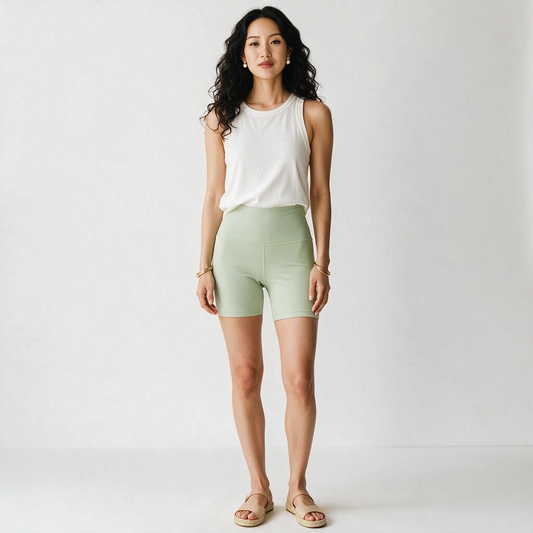 A model wearing Lynn's Closet Boutique Lululemon Align high-rise mint green 6-inch shorts with a white tank top.