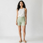 A model wearing Lynn's Closet Boutique Lululemon Align high-rise mint green 6-inch shorts with a white tank top.