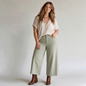 Lynn's Closet Boutique Anthropologie Maeve Colette moss green cropped wide-leg pants with raw hem on a model